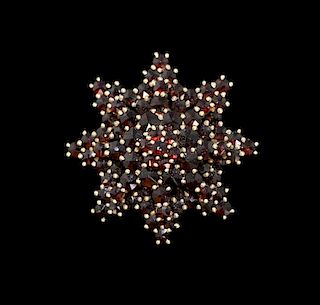 Garnet brooch in the form of a star, set in 18 ct gold