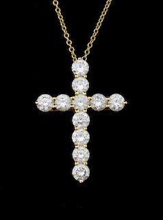 Tiffany and Co diamond Cross pendant, set with 11 round brilliant cut diamonds in a claw setting mounted in 18ct yellow gold 