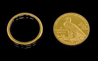 Five dollar gold coin and a 22 ct gold wedding ring.