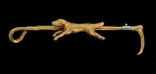 Gold and platinum bar brooch in the form of a riding crop with a dog to the centre, 9 ct, length 5.9 cm
