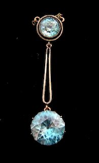 1930's  drop pendant, set with a  blue zircon measuring 7.50 mm  suspending a larger zircon measuring 12.50 mm in white metal