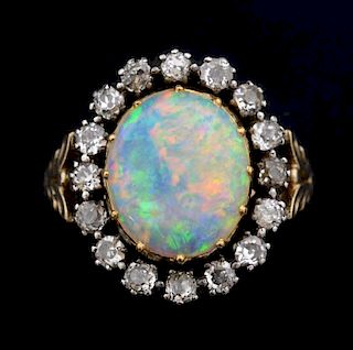 Late Victorian opal and diamond cluster ring, the opal measuring 13.49 x 11.50 mm x 3.44 mm with an old-cut diamond surround 