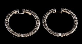 A pair of diamond hoop earrings,  round brilliant cut diamonds hinged opening in 18 ct white gold, estimated total diamond we