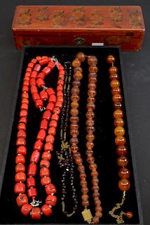 Two amber and two coral necklaces together with a red bead necklace. boxed