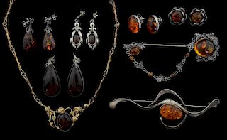 A collection of amber jewellery, mainly silver settings, including a large brooch signed PB
