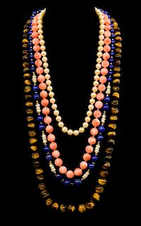 A cultured pearl necklace, tigers-eye bead necklace, coral necklace and a lapis and pearl necklace
