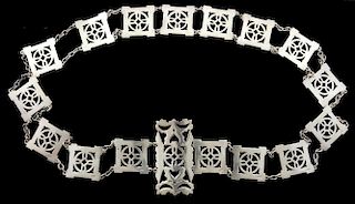 Silver belt in Arts & crafts manner, square sections with a flower form cross within a circle, joined by chain links, Birming