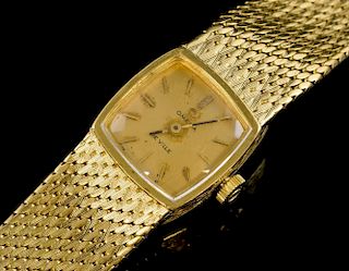 Lady's Omega De Ville 18 carat gold bracelet watch, square dial on an integral gold Omega bracelet. Mechanical movement .