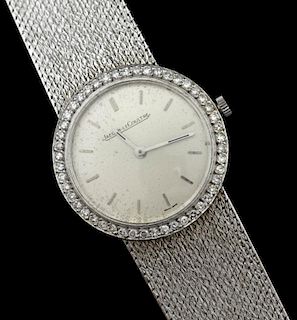 Ladies Jaeger LeCoultre gold and diamond watch, silvered dial with applied baton hour markers, polished baton hour and minute