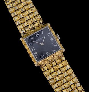 Lady's Vacheron Constantin 18ct gold bracelet watch, black dial with white roman numerals, on basket weave gold integral stra
