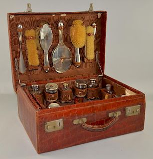 Crocodile skin dressing case, the fitted interior with near complete crocodile skin and silver mounted ladies dressing items,