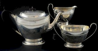George V silver three piece tea service, comprising teapot, cream jug and sugar bowl, with reeded decoration and oval section
