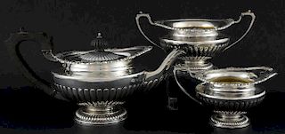 Edward VII silver three piece tea service, comprising teapot, cream jug and sugar bowl, with moulded gadrooned and shell deco