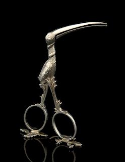 Pair of German silver sewing scissors moulded as a stork and revealing a swaddled baby when the scissors are opened, '800' st