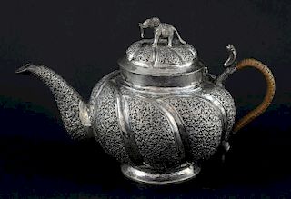 Indian white metal teapot with embossed floral decoration and elephant finial on round base, gross weight 13.2oz, 413g,