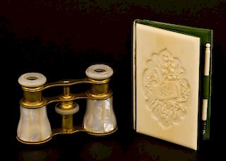 Early 20th century ivory mounted notebook/wallet with floral carved cartouche, and a pair of mother of pearl and gilt metal o