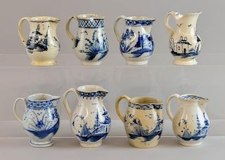 Eight 18th century blue and white small jugs