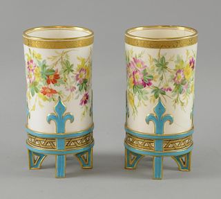 Pair of vases with blue and gilt decoration and hand painted flowers. 19 cm high