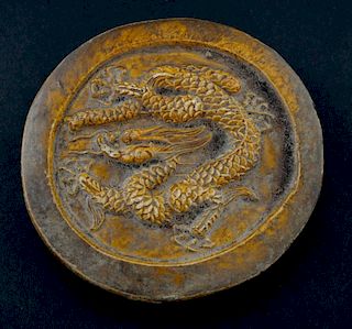 Chinese imperial ceramic roof tile, of circular form with mustard yellow glaze the centre decorated with a five clawed coiled