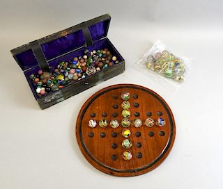 Victorian solitaire board and a quantity of marbles.