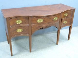19th century mahogany serpentine sideboard, drawer above two cupboard doors flanked by deep drawer and cupboard on square tap
