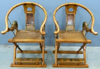 Two Chinese elm and brass mounted folding hunting chairs,