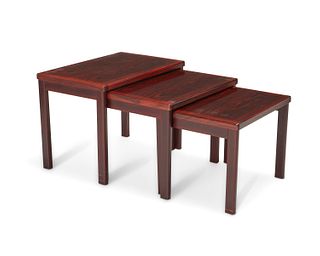 A set of Danish modern rosewood nesting tables Circa 1960s Largest: 18" H x 24.25" W x 15.75" D; smallest: 15.25" H x 19.25" W x 15.75" D