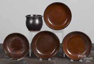 Four redware shallow bowls, together with a small crock, 3 3/4'' h., 7'' dia.