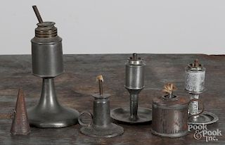 Four American pewter oil lamps, 19th c., together with a tin lamp and snuffer, tallest - 7 1/4''.
