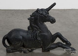 Cast iron unicorn andiron, 19th c., 16 1/2'' h., 23 1/2'' w.