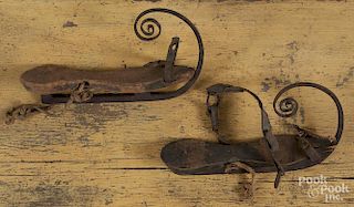 Pair of painted pine and iron ice skates, 19th c., with curled terminals, 11'' l.