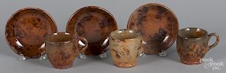 Three Pennsylvania redware cups and saucers, attributed to Jacob Medinger.