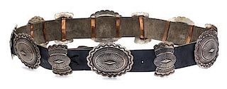 * A Sterling Silver, Copper and Leather Concho Belt, Navajo, 379.20 dwts. (including leather)