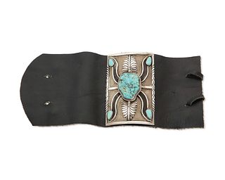 A small silver and turquoise ketoh arm guard