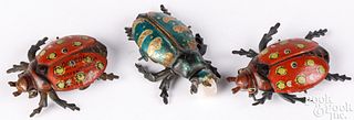 Three tin lithograph beetle penny toys