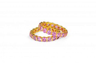 A Pair of Pink Sapphire and Gold Eternity Bands