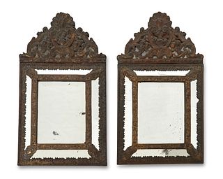 A pair of repousse brass wall mirrors