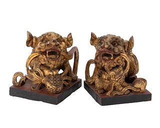 A pair of Chinese carved giltwood guardian lions