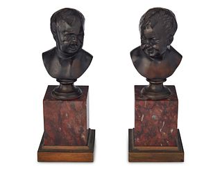 An opposing pair of bronze child busts