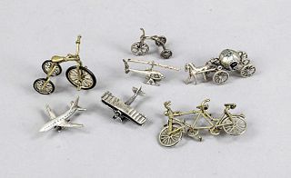 Seven miniature vehicles, Italy, 20th c., silver 800/000, 2 airplanes, helicopter, 2 tricycles, tandem and Cinderella's carriage, l. to 7 cm, total we