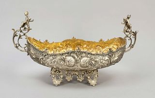 Jardiniere, c. 1900, plated, gilded interior, on 4 feet, the side handles decorated with fully plastic putti, the walls with rich floral relief decora