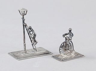 Two miniatures, 20th century, silver 835/000, 1x man on a penny-farthing, 1x man climbing a ladder leaning on a lantern, each on a rectangular plinth,