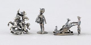 Three miniatures, early 20th century, silver hallmarked, St. George fighting with the dragon, sleigh ride and putto, l. to 4 cm, total weight ca. 59 g