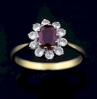 Ruby and diamond cluster ring, set with a central ruby of 0.6 carat within a border of ten diamonds, total diamond weight est