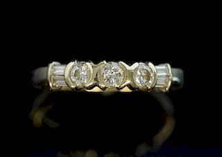 Contemporary diamond ring set with three brilliant and two baguette cut  diamonds in 18 ct white and yellow gold