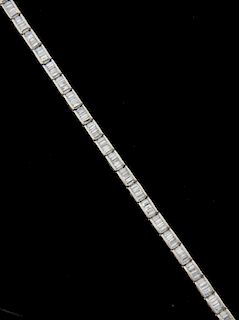 Diamond line bracelet, set with baguette cut diamond in a channel setting. mounted in 18ct white gold. Estimated total diamon