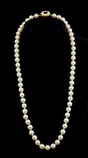 Cultured pearl necklace, single row of 60 round pearls measuring 6.5mm with garnet and seed pearl clasp in 9ct gold.