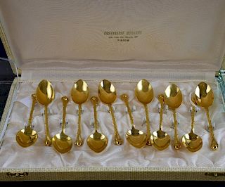 Set of twelve French gilt metal coffee spoons with leaf moulded bowls and coffee bean finials, in fitted case,