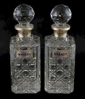Pair of modern silver mounted cut glass decanters and stoppers with silver decanter labels,