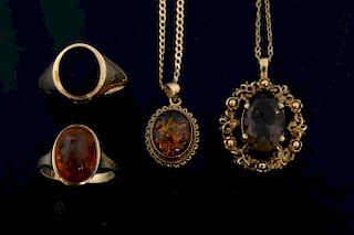 Gold and onyx signet ring, an amber ring and pendant and a smoky topaz pendant on gold chains, all 9 ct